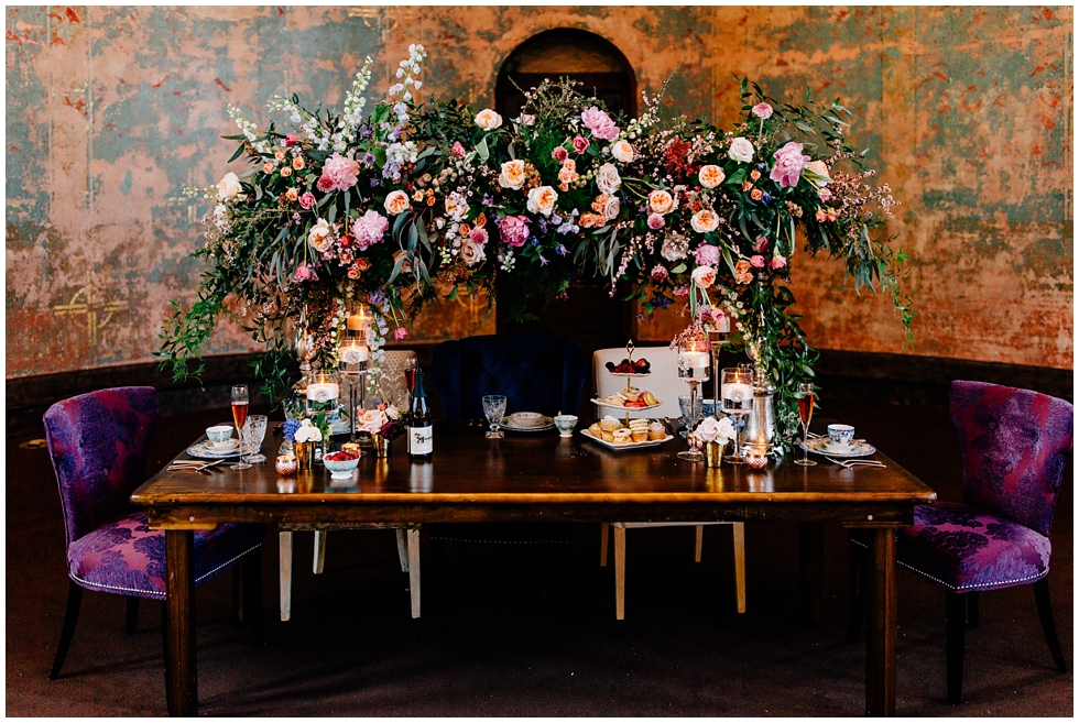 Wedding table arrangement: Floral, baked goods, champagne. 